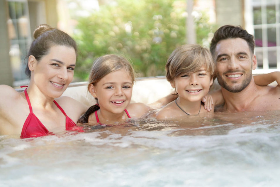 Happy family posing in swim spa