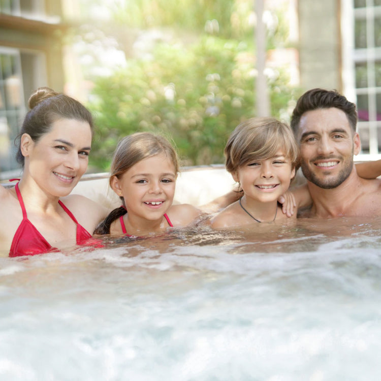 Happy family posing in swim spa